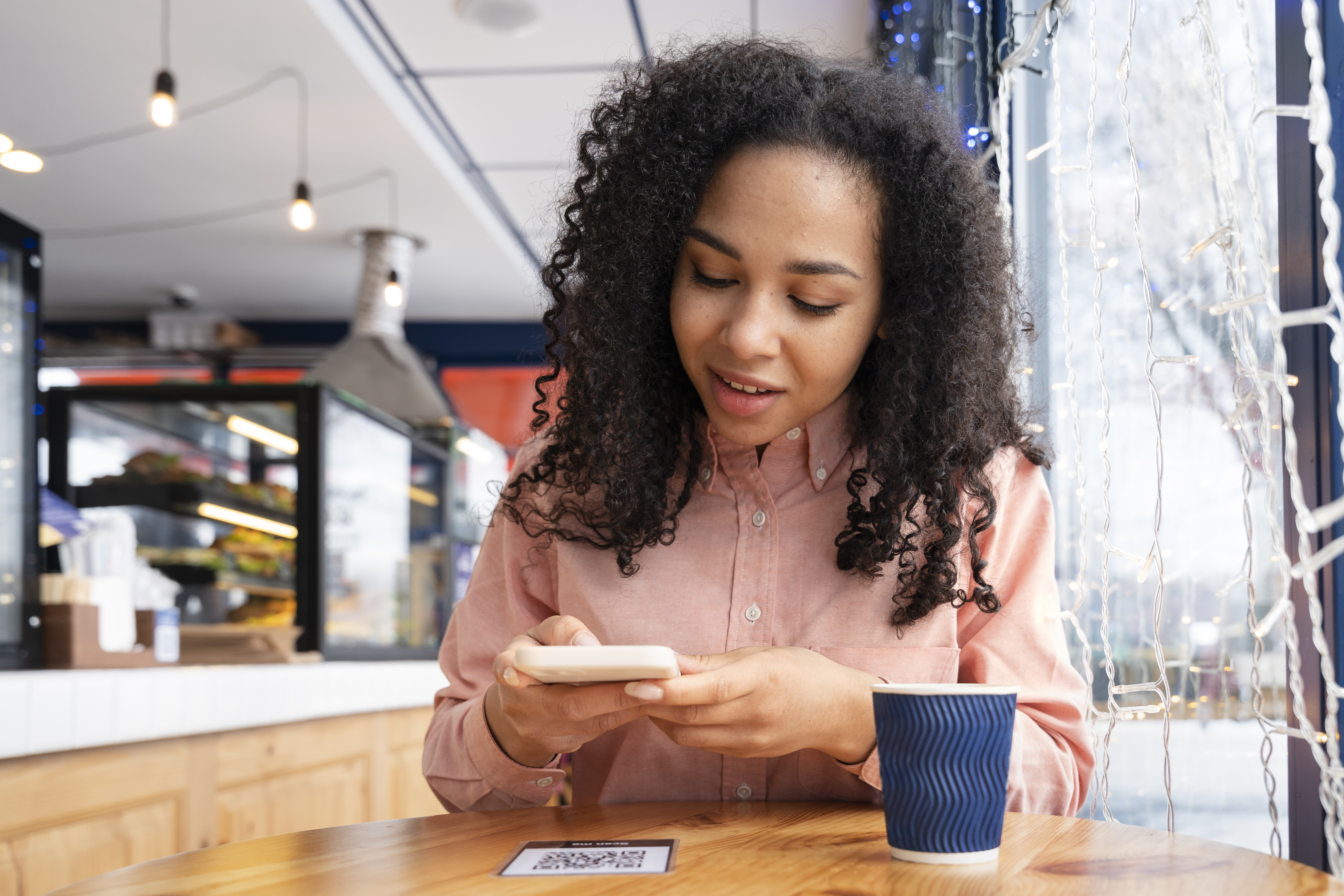 medium-shot-woman-holding-smartphone