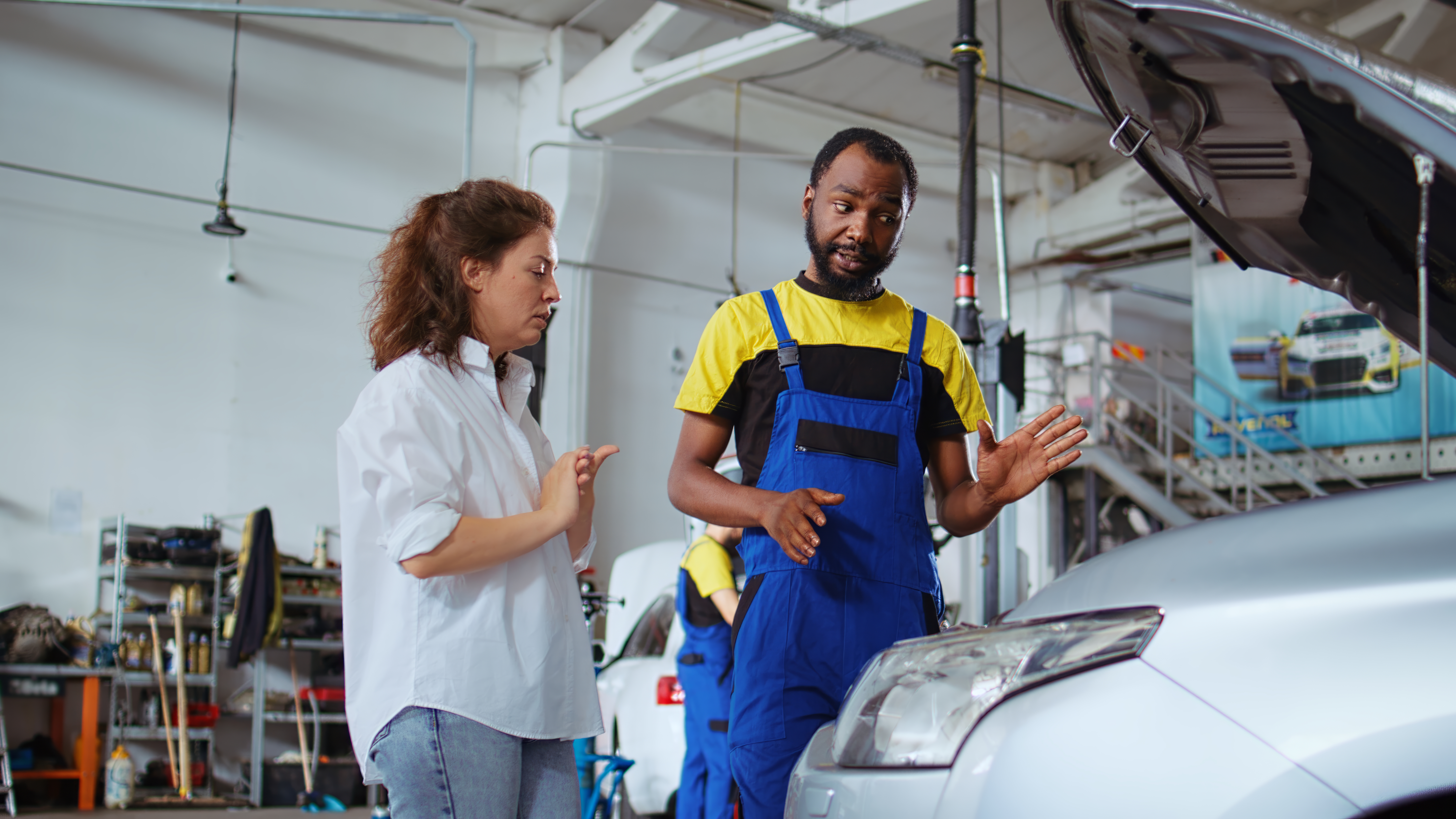 serviceman-showing-customer-car-changes