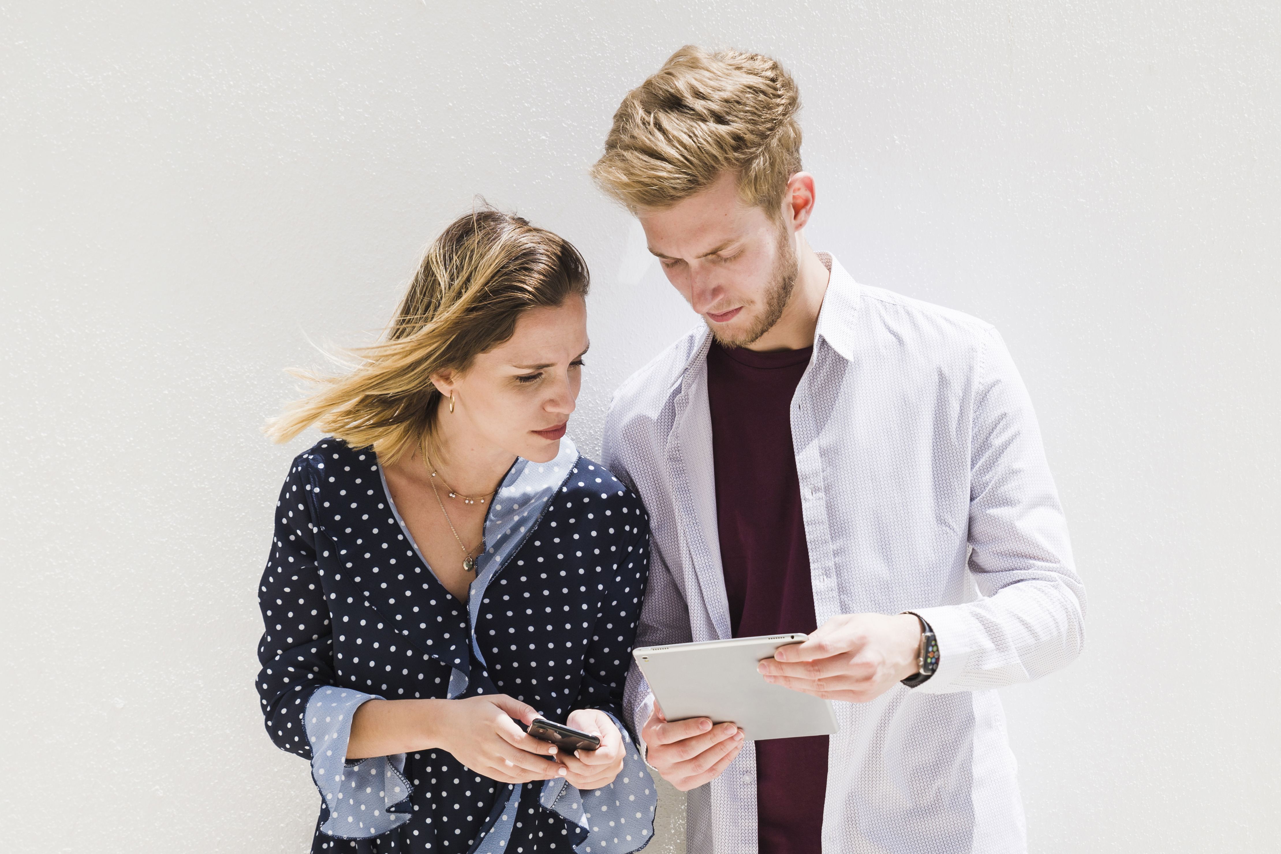 young-couple-using-smartphone-digital-tablet